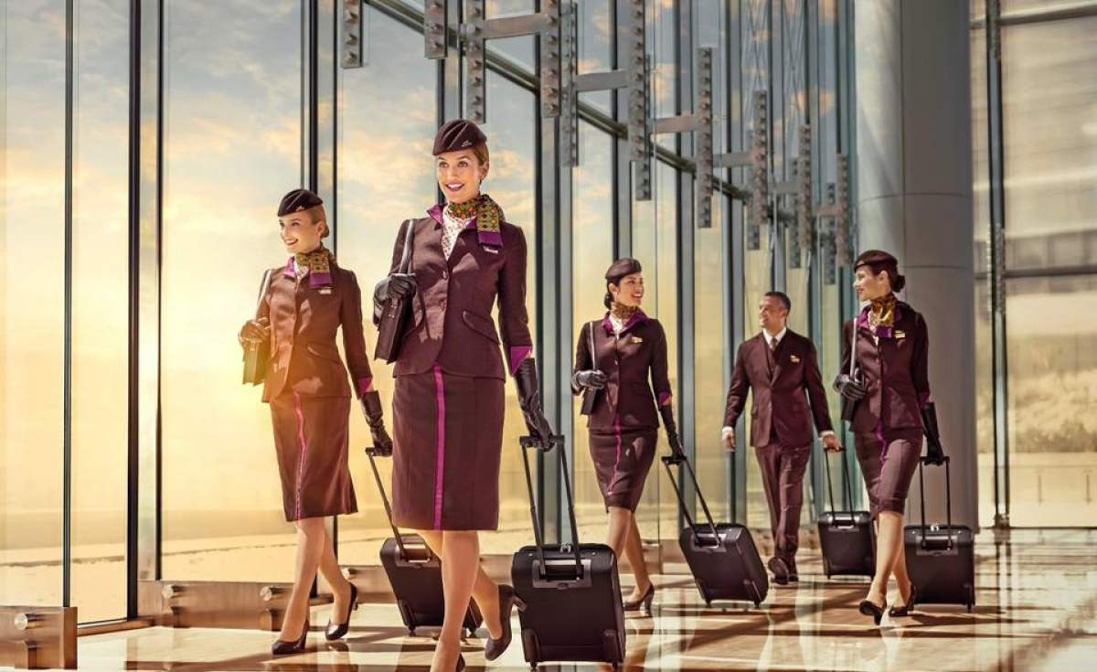 a group of stewardesses walking with luggage