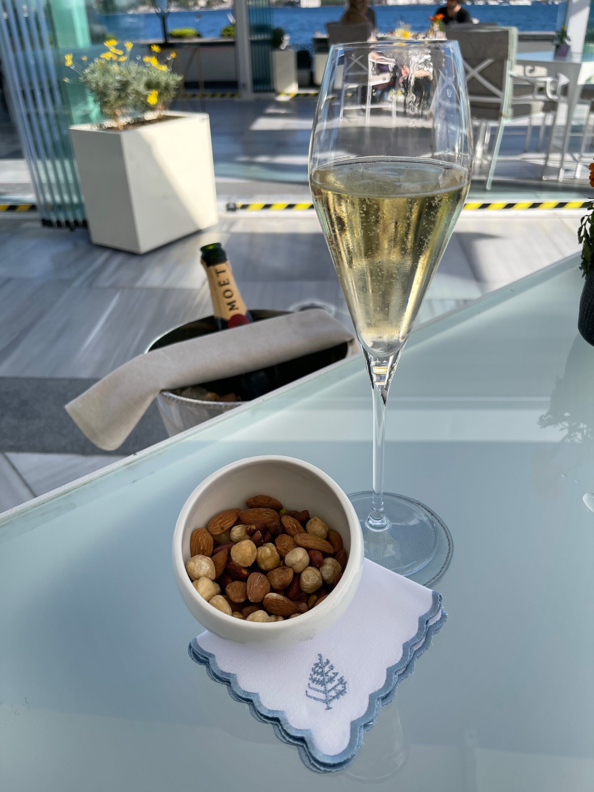 a glass of champagne and a bowl of nuts