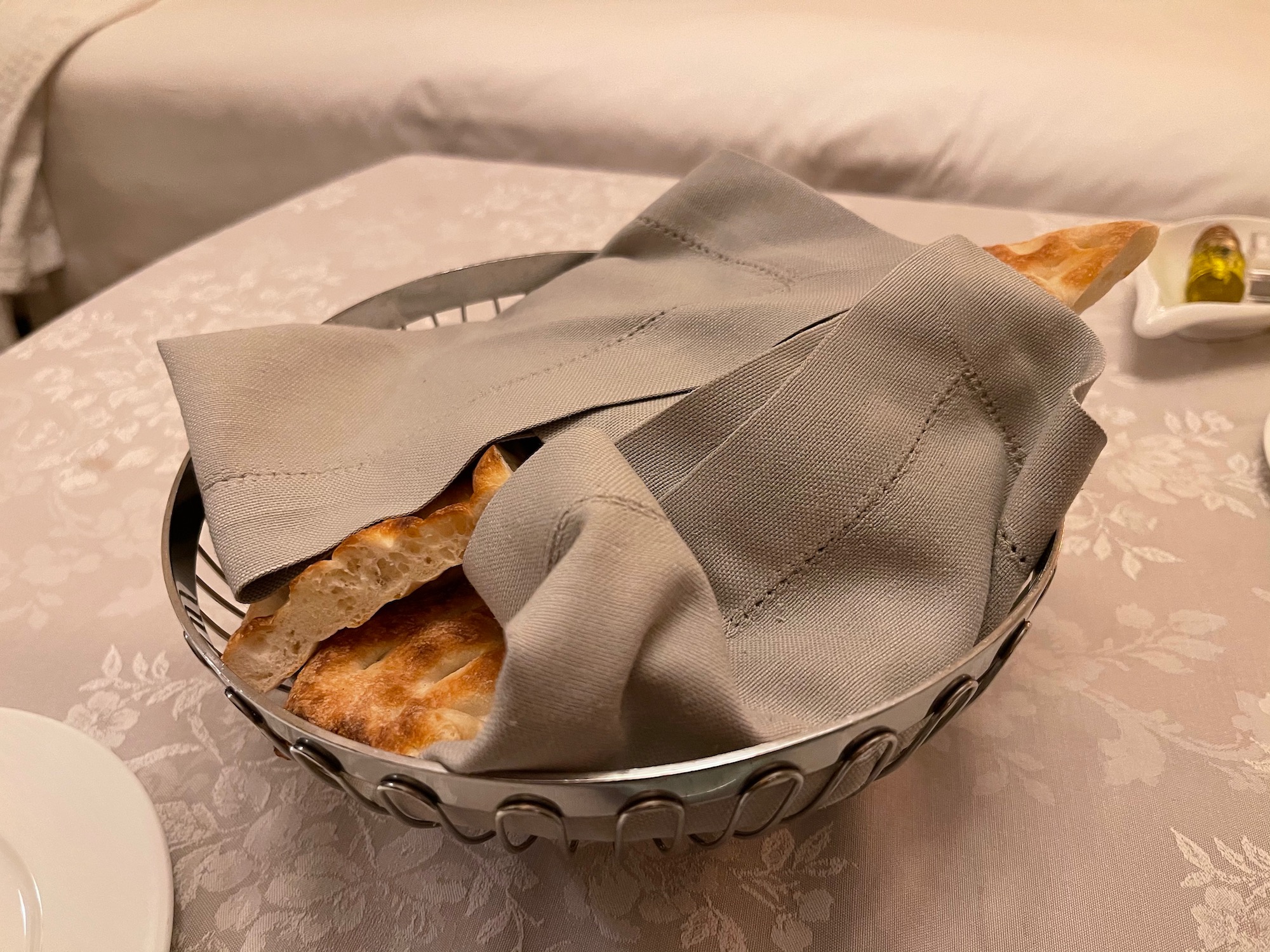 a bowl of bread and napkin