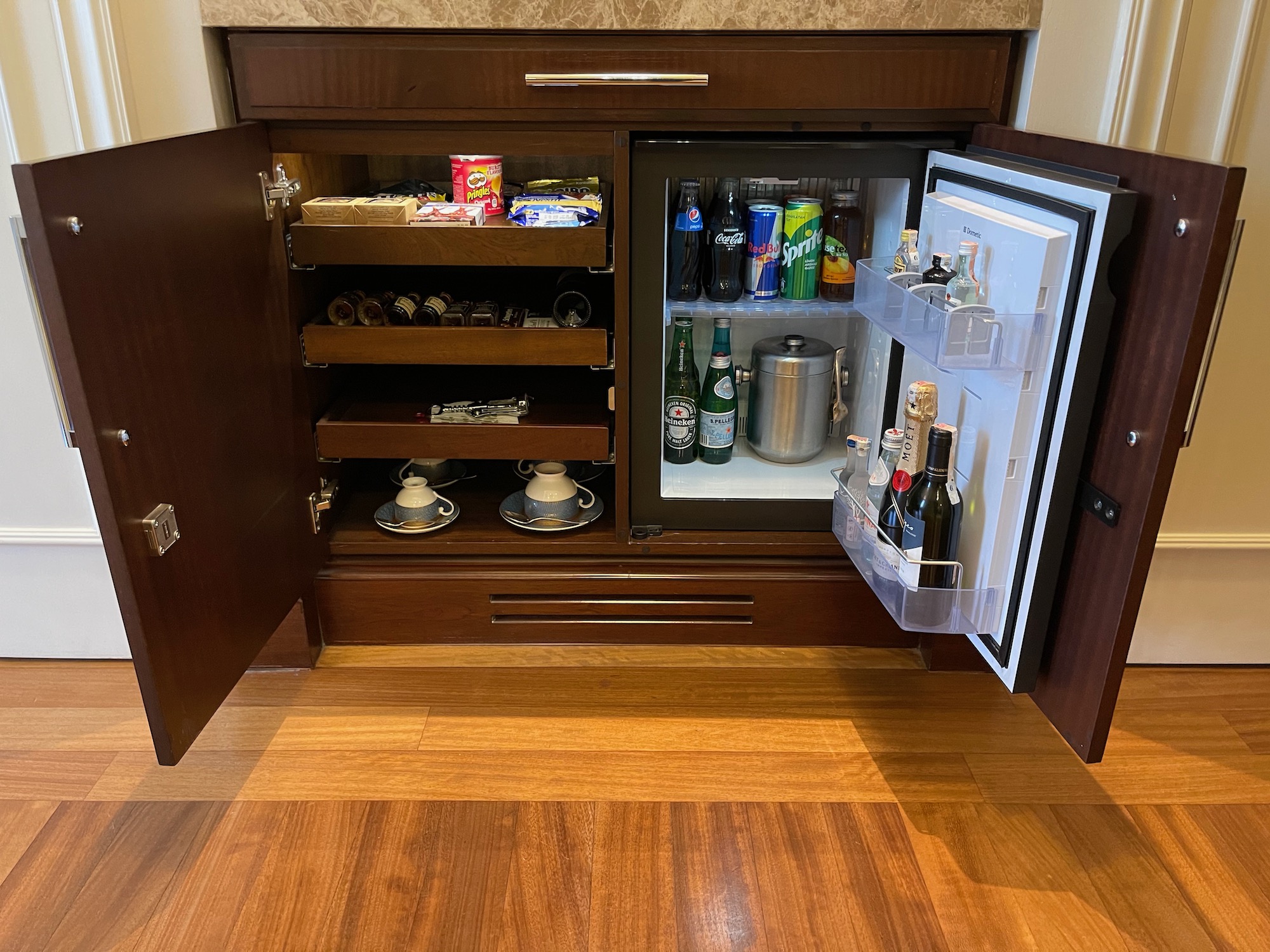 a mini fridge with drinks and snacks inside