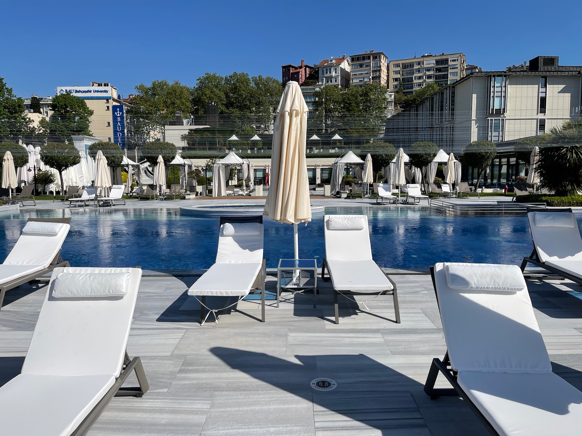 a pool with lounge chairs and umbrellas