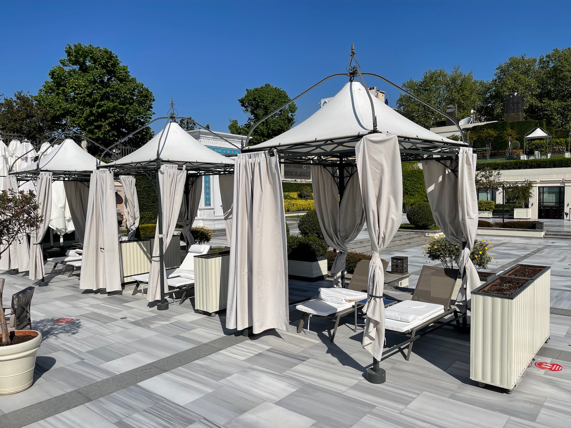 a group of chairs and umbrellas on a patio