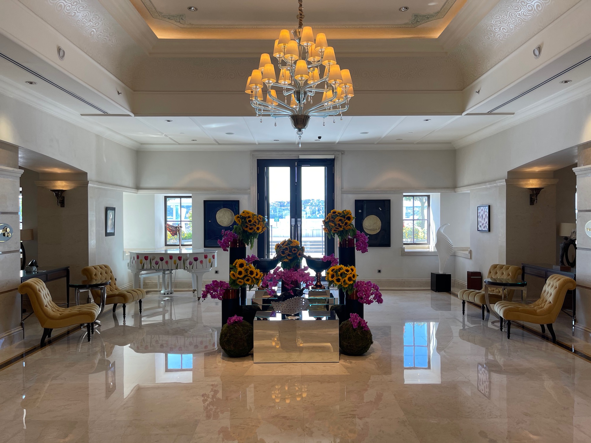 a room with a chandelier and flowers