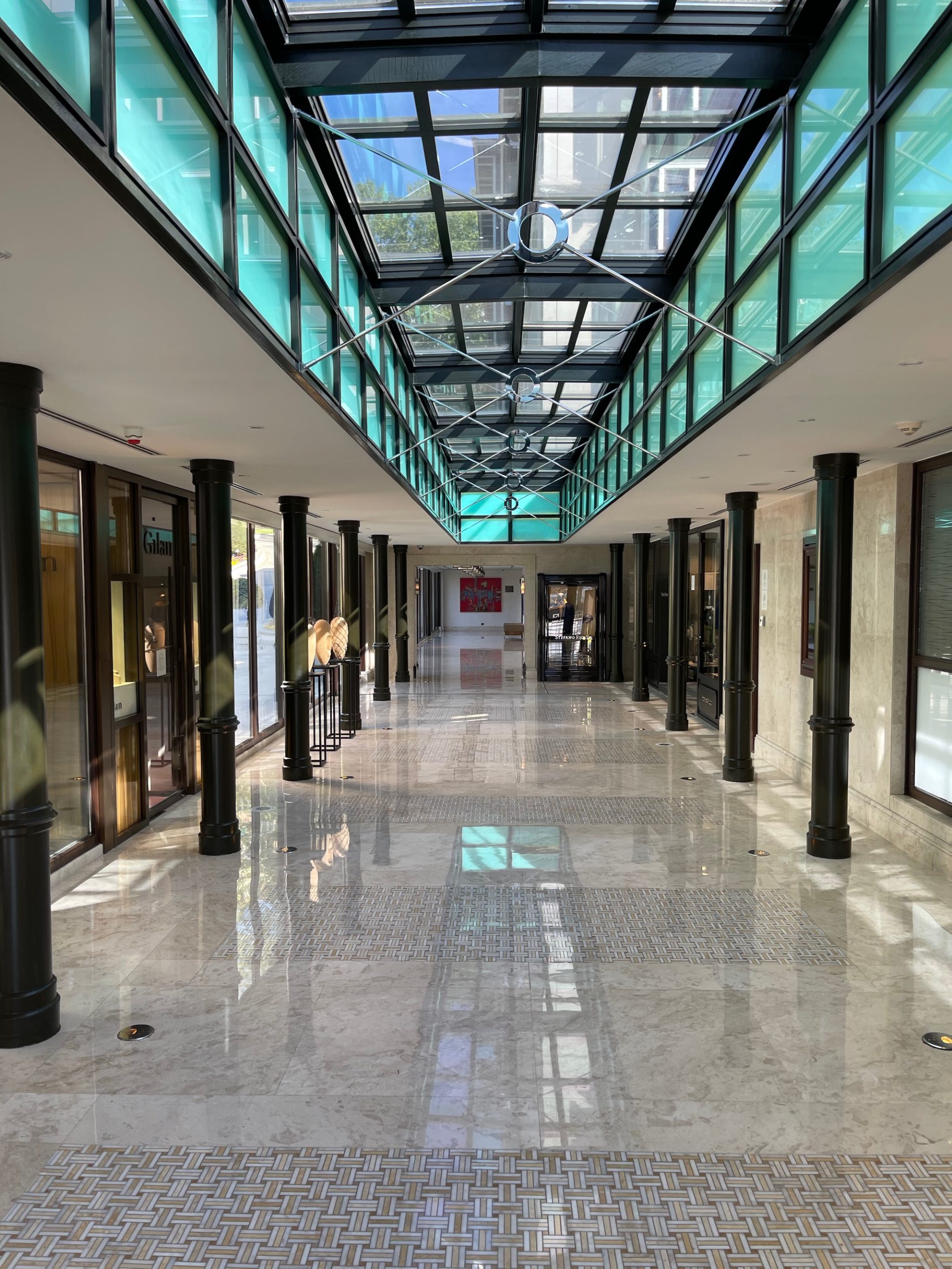 a hallway with glass ceiling and windows