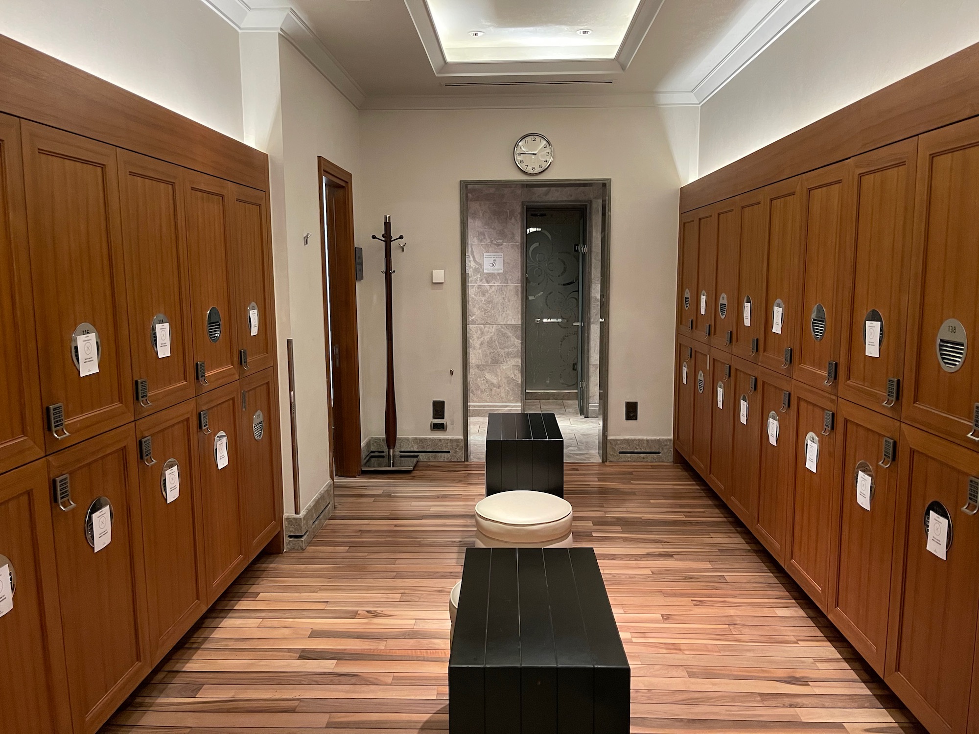 a hallway with lockers and toilet seats