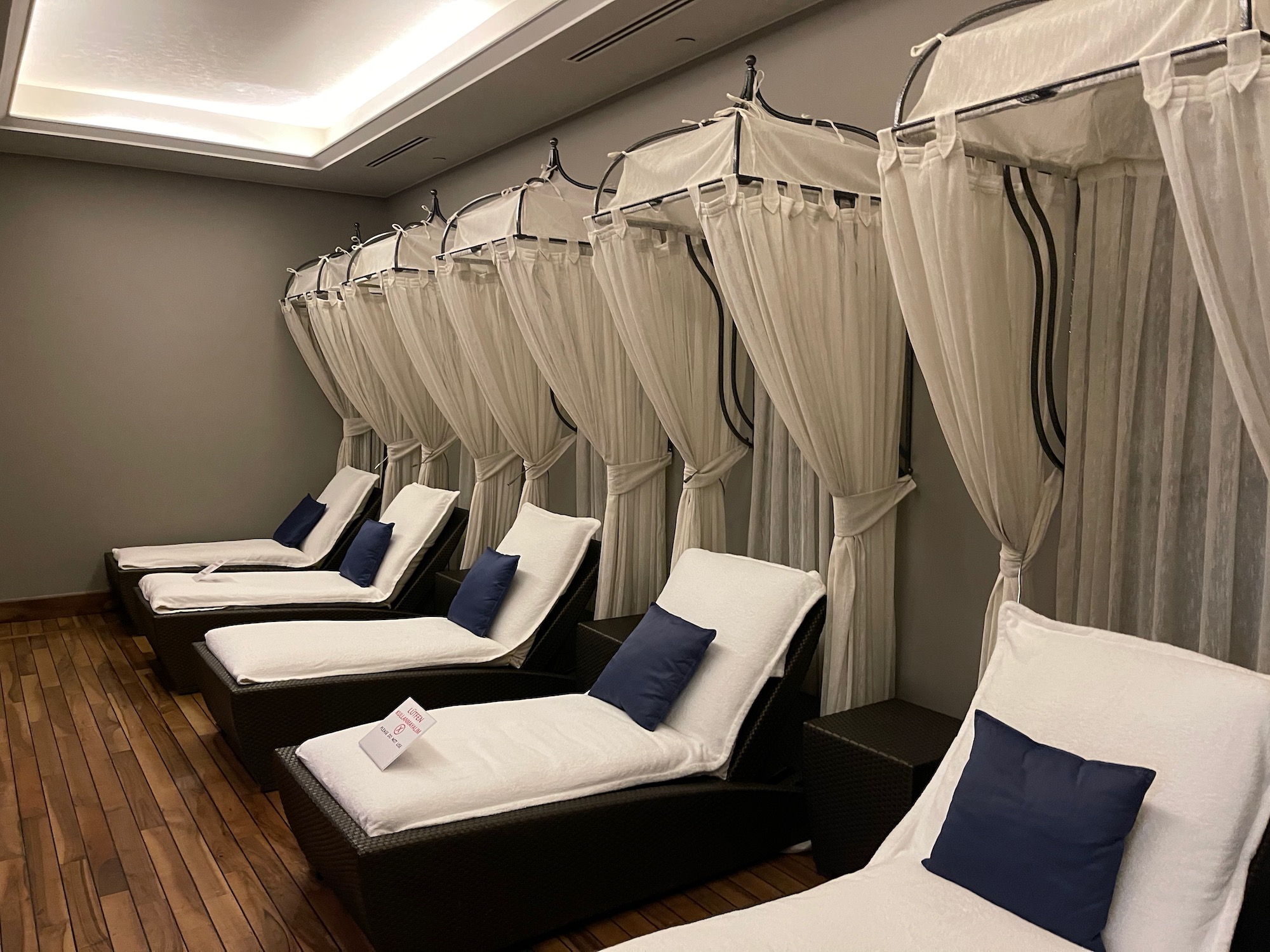 a group of beds with white curtains