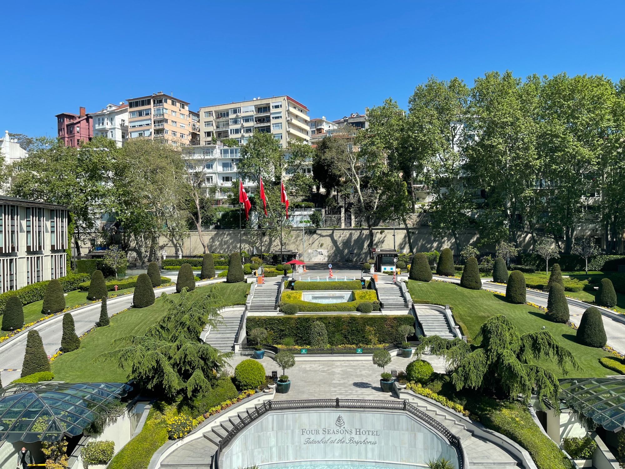 a park with a fountain and trees with Lombard Street in the background