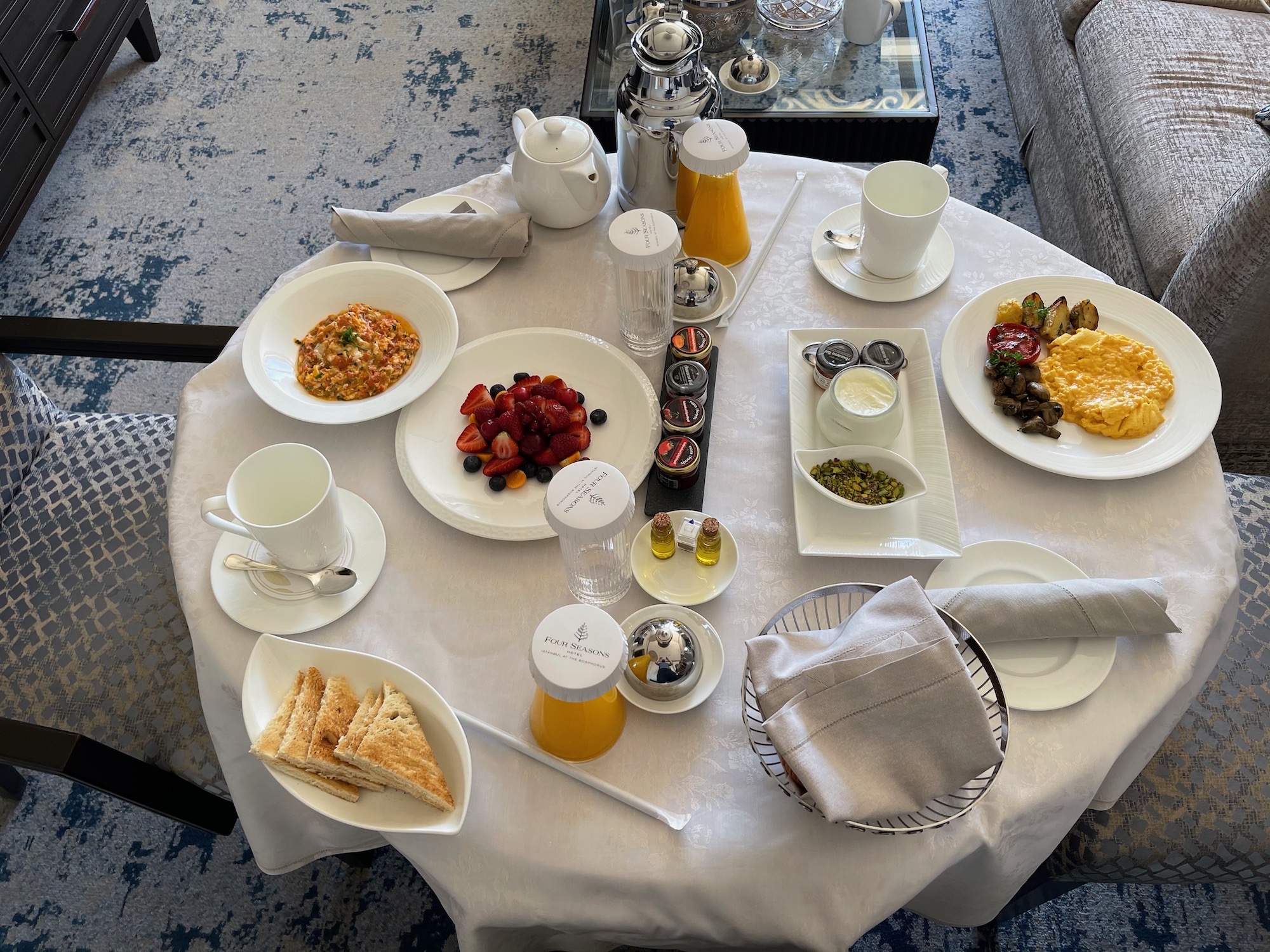 a table with plates of food and drinks