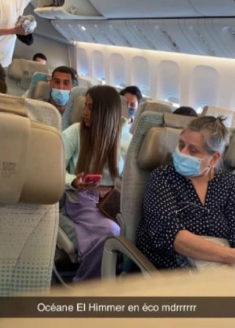 people on an airplane with a mask on