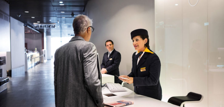 a woman standing at a reception desk