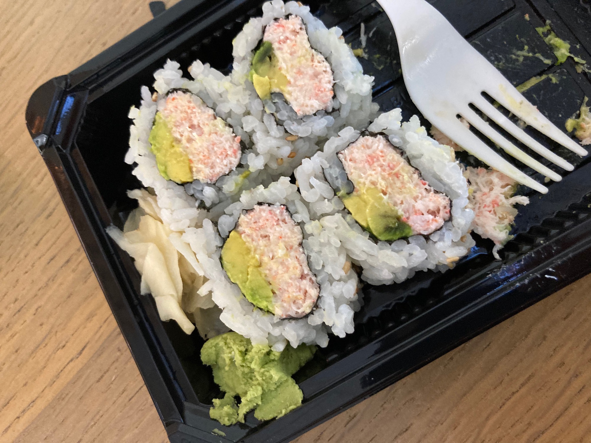 a plate of sushi with a fork
