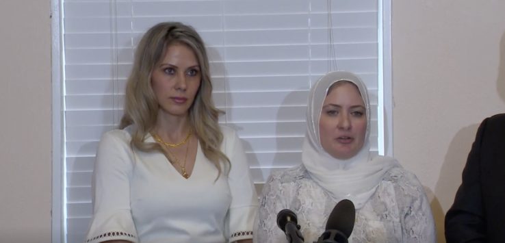 a group of women standing in front of microphones