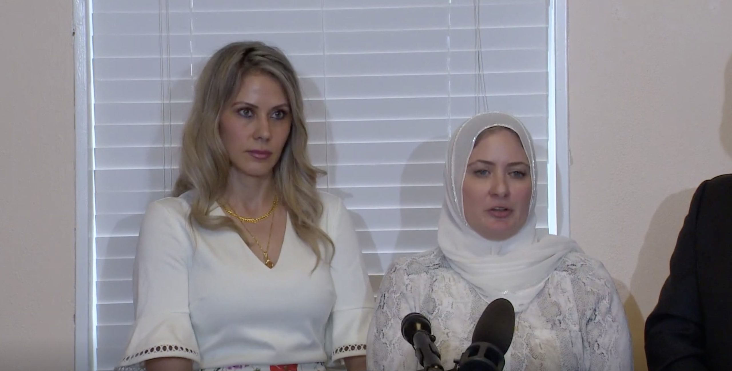 a group of women standing in front of microphones