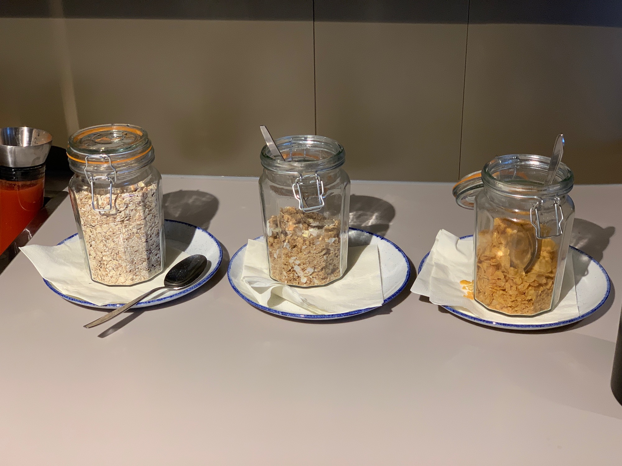 a group of jars of cereal and cereal on plates
