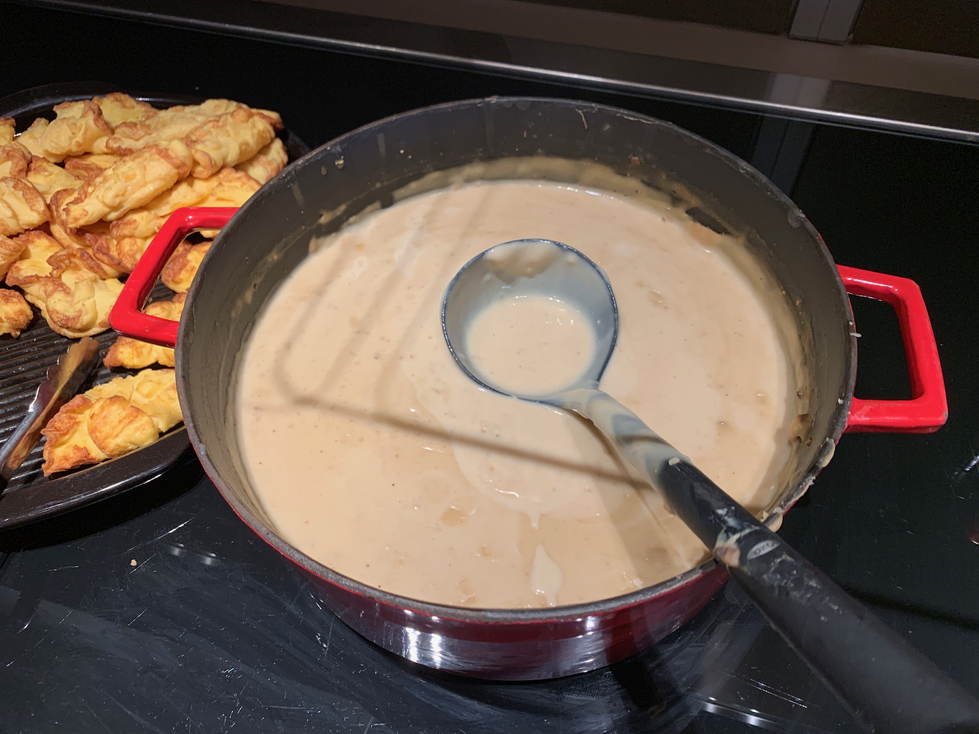 a pot of soup with a ladle