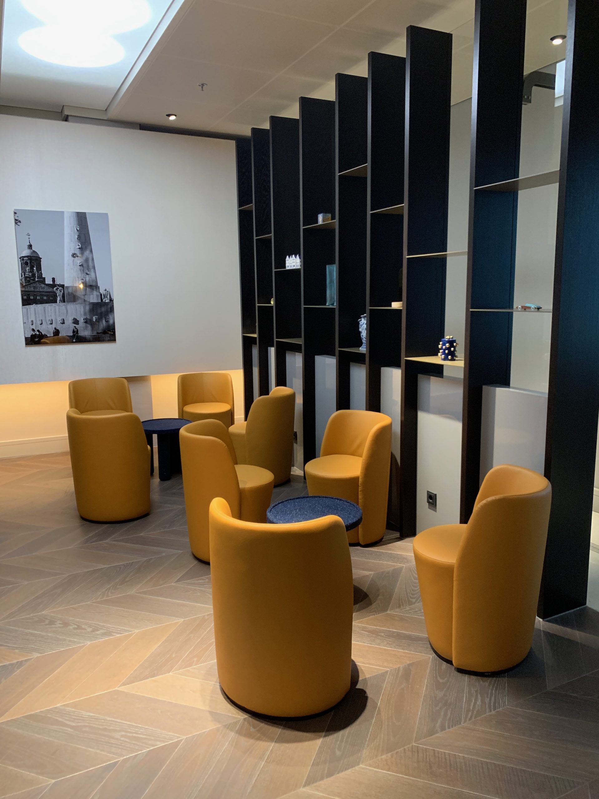 a room with yellow chairs and a blue table