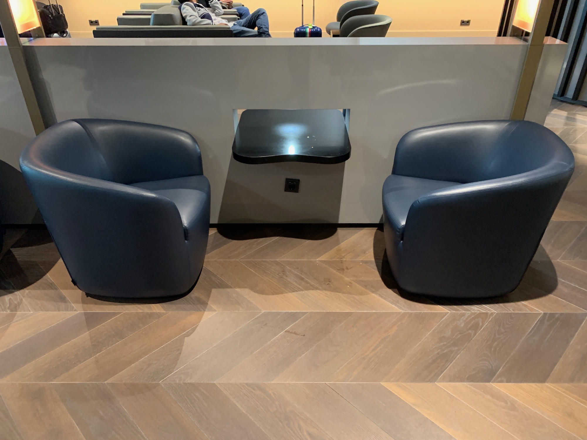 a reception desk with chairs and a table