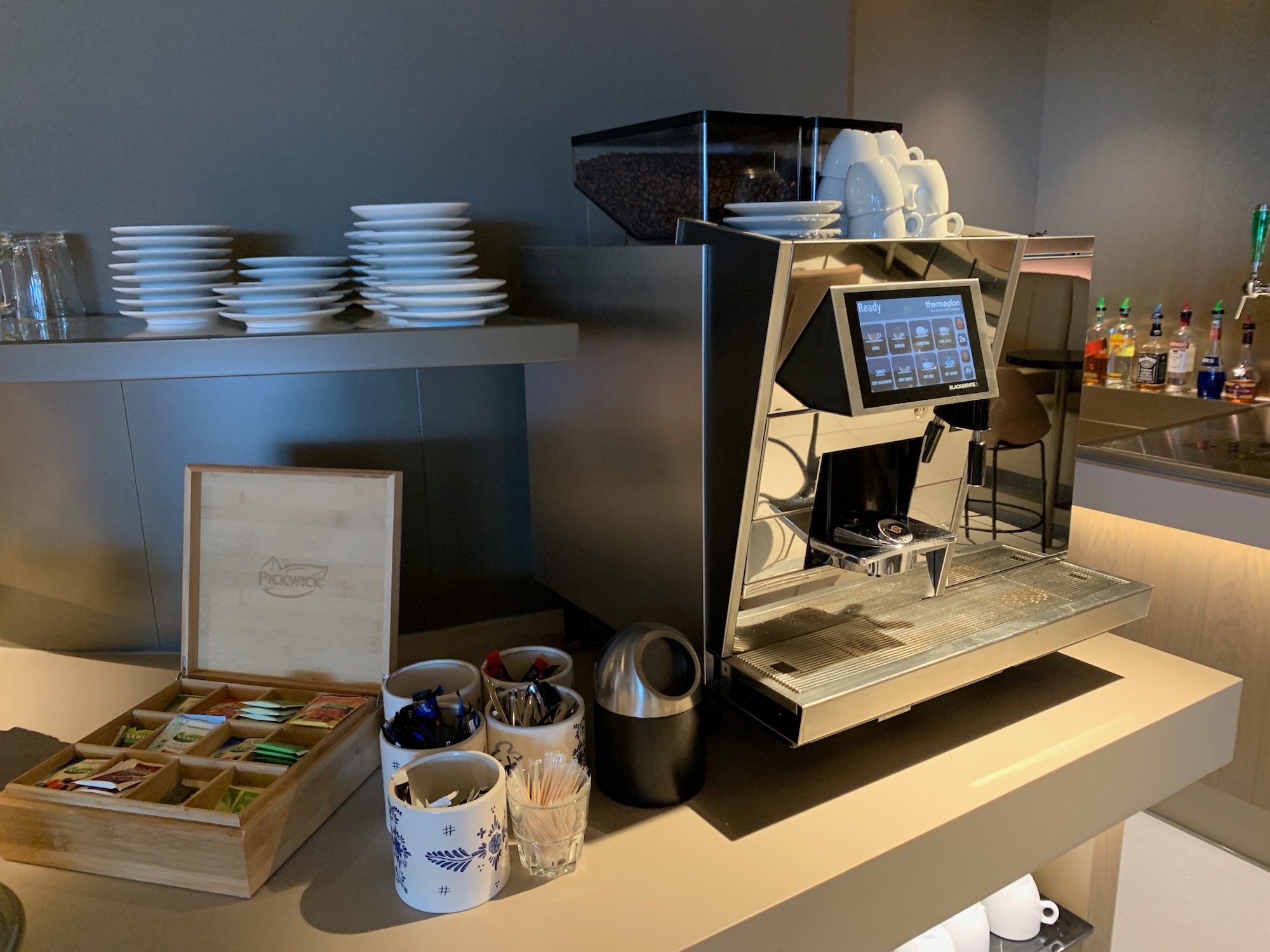 a machine with a screen and cups on a counter