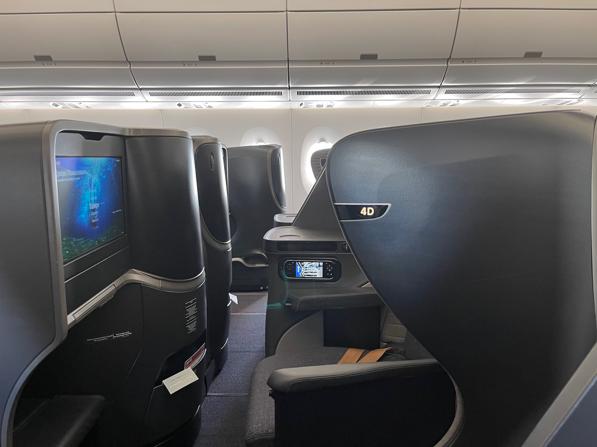 a seats and a tv in an airplane