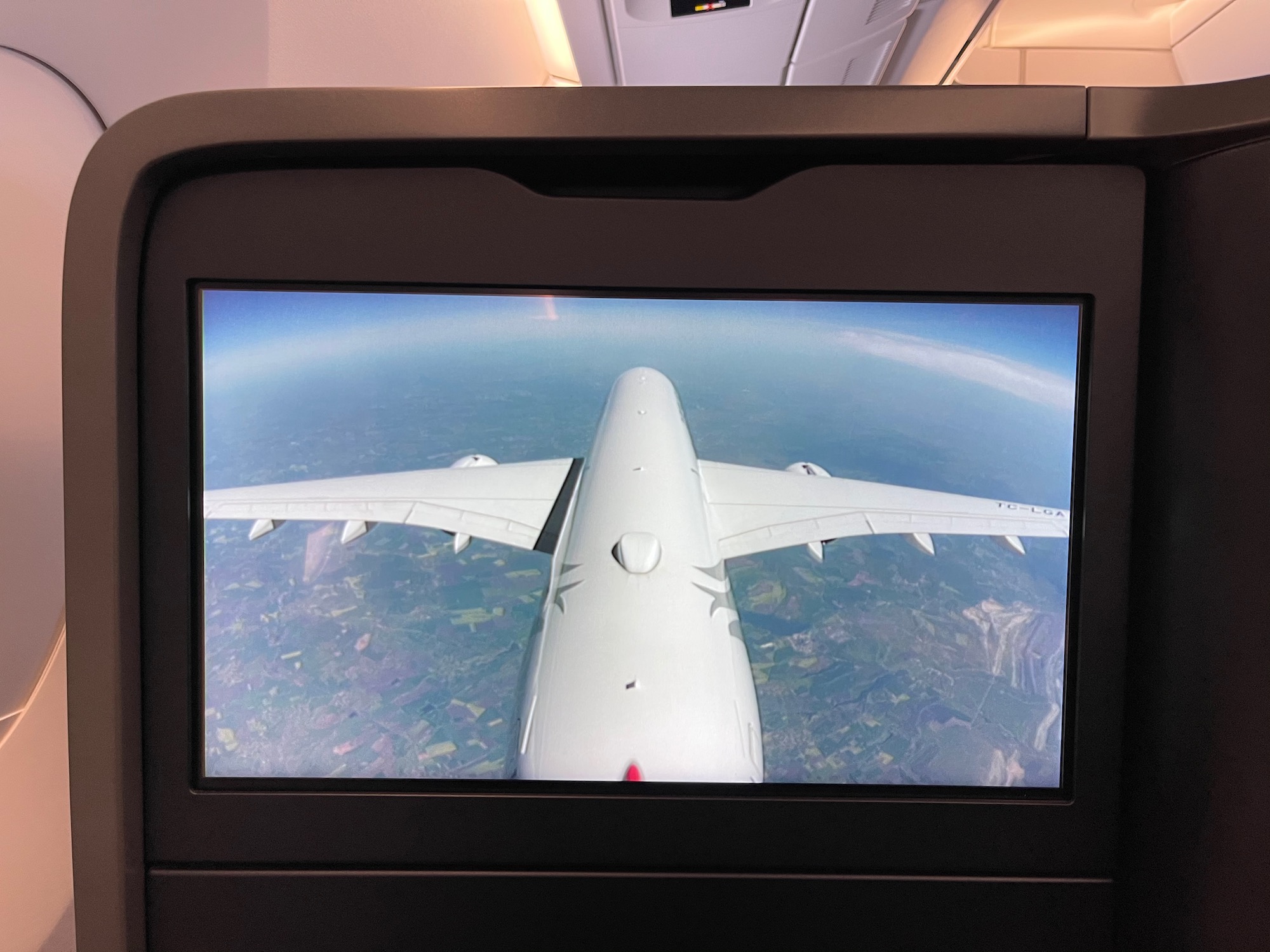 a screen with a plane wing in the air