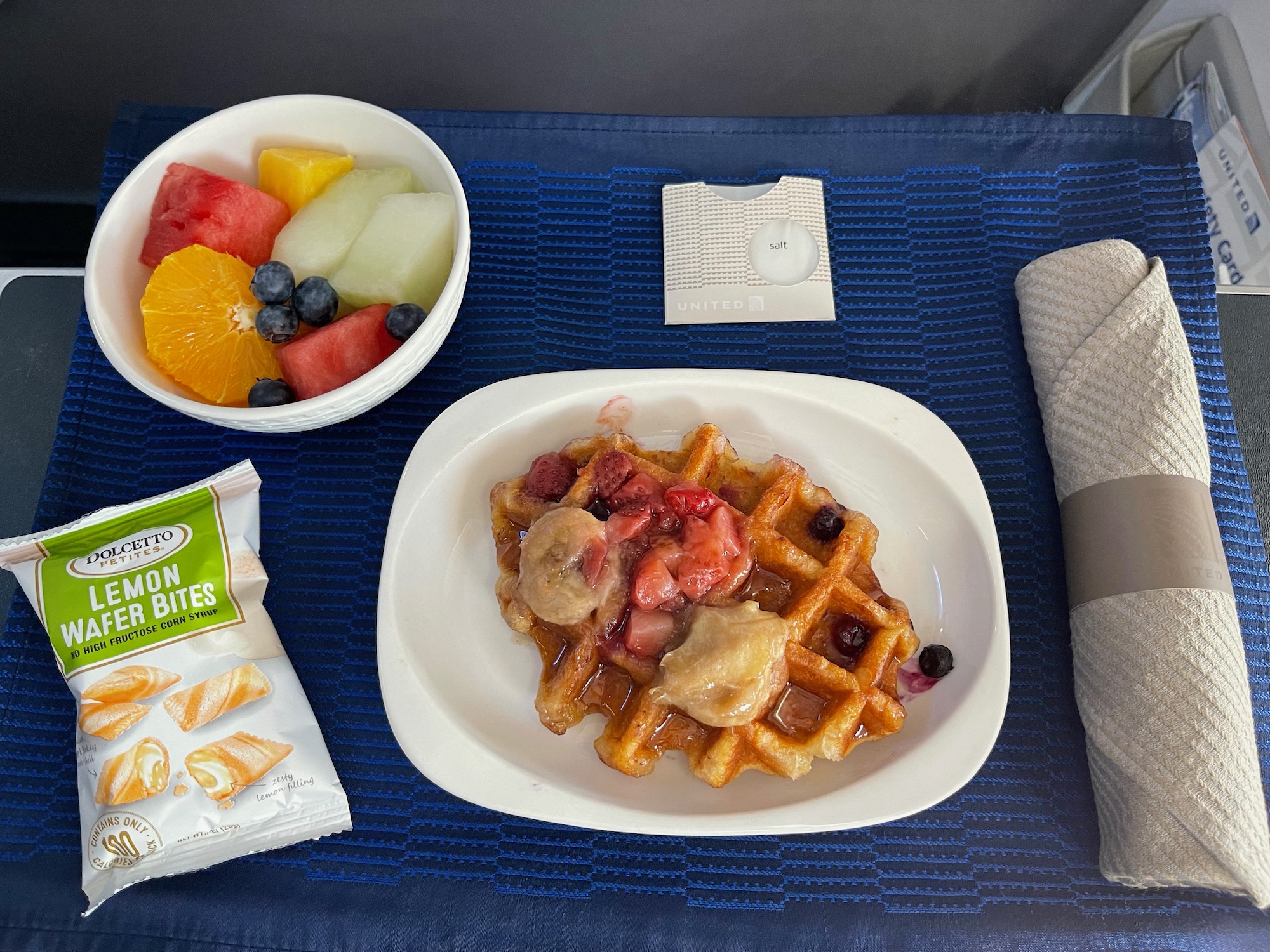 a plate of food and a bowl of fruit