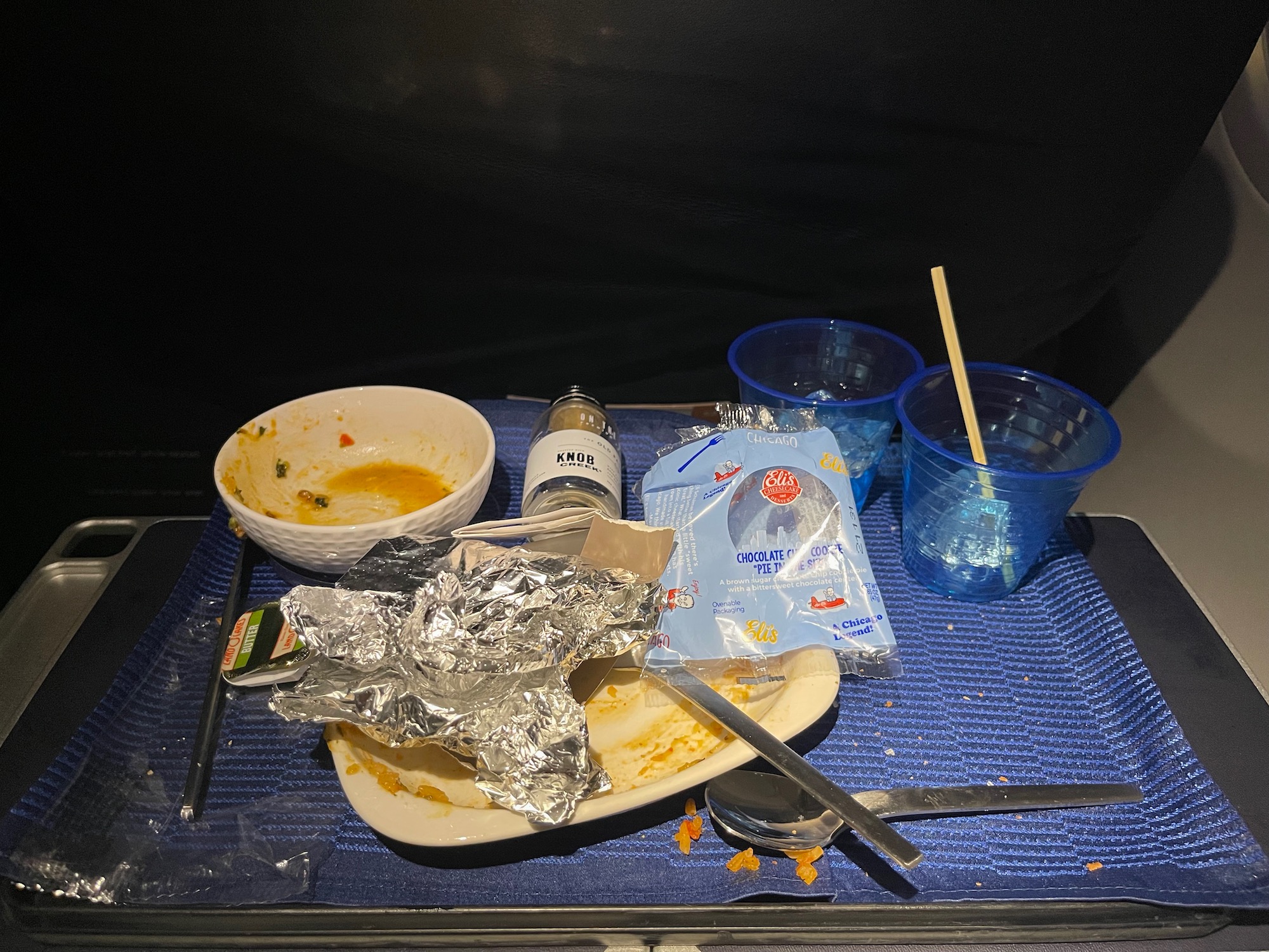 a plate with foil and cups on a table