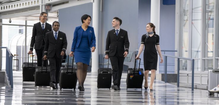 a group of people walking with luggage