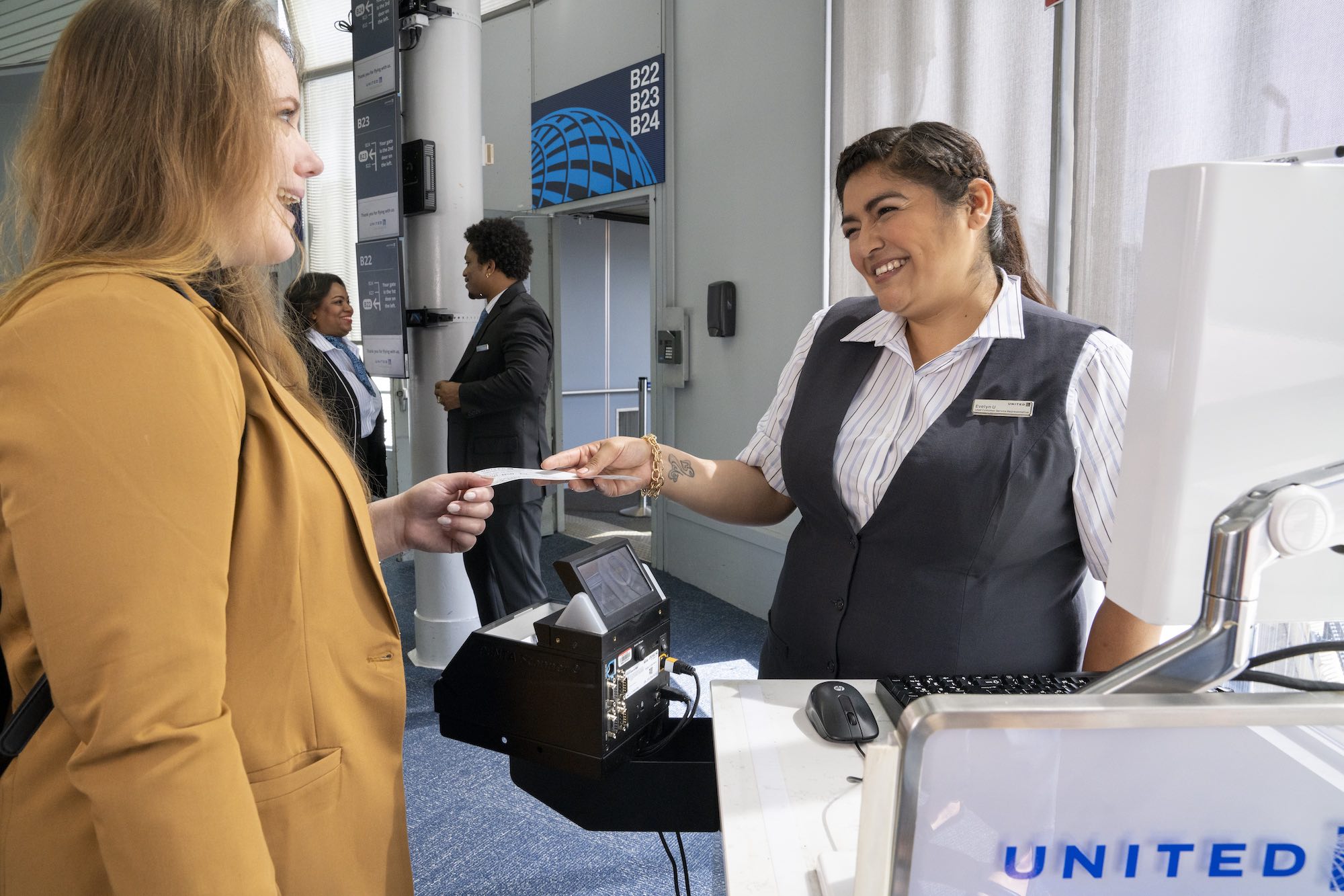 a woman handing a ticket to a woman