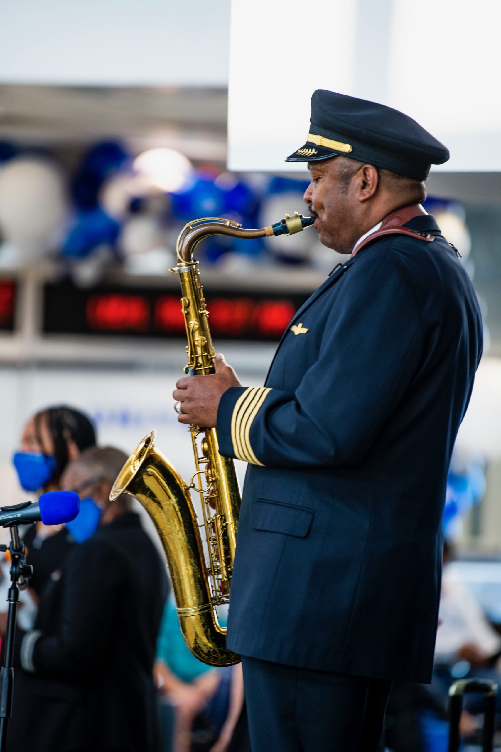 a man in uniform playing a saxophone