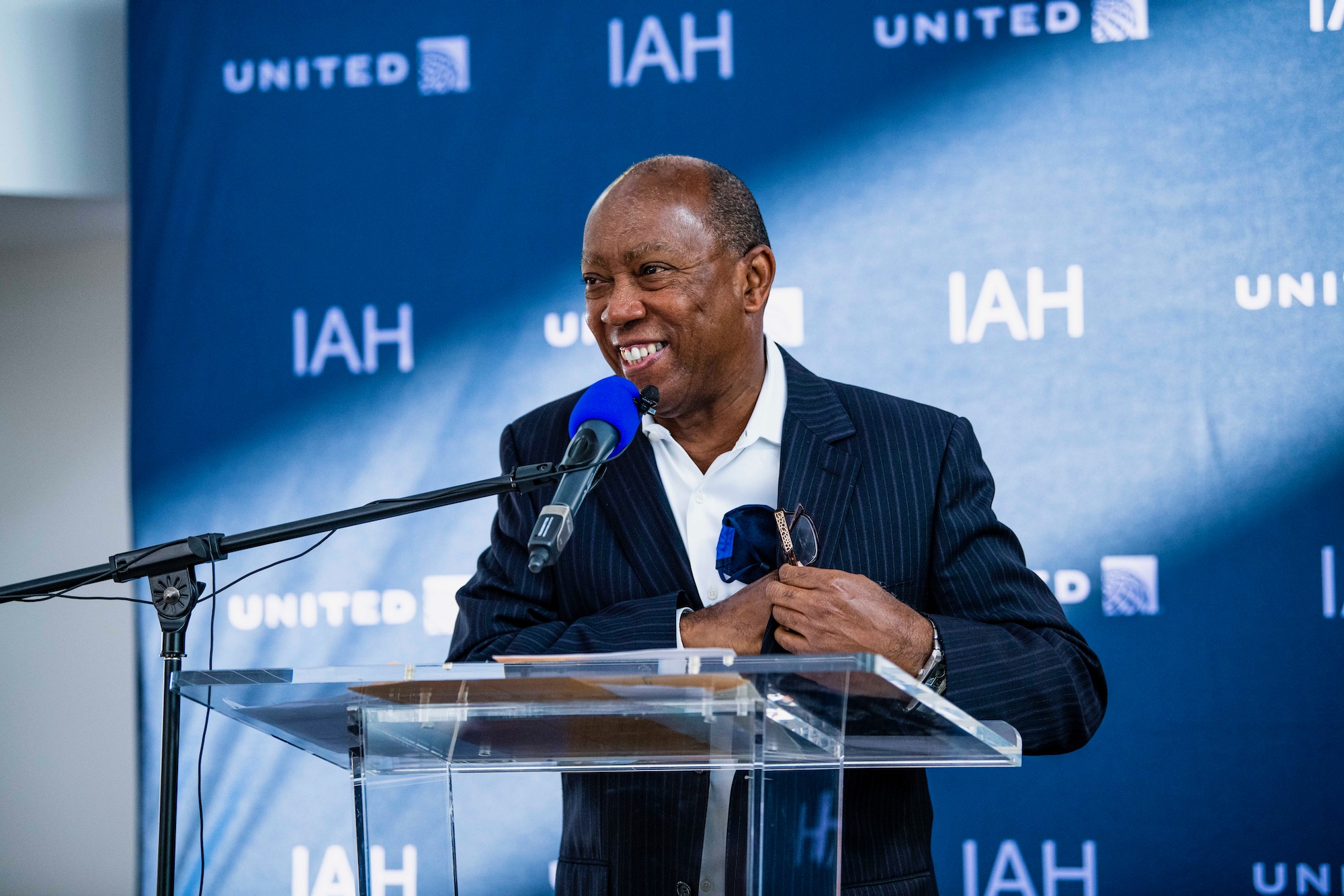 a man standing at a podium with a microphone