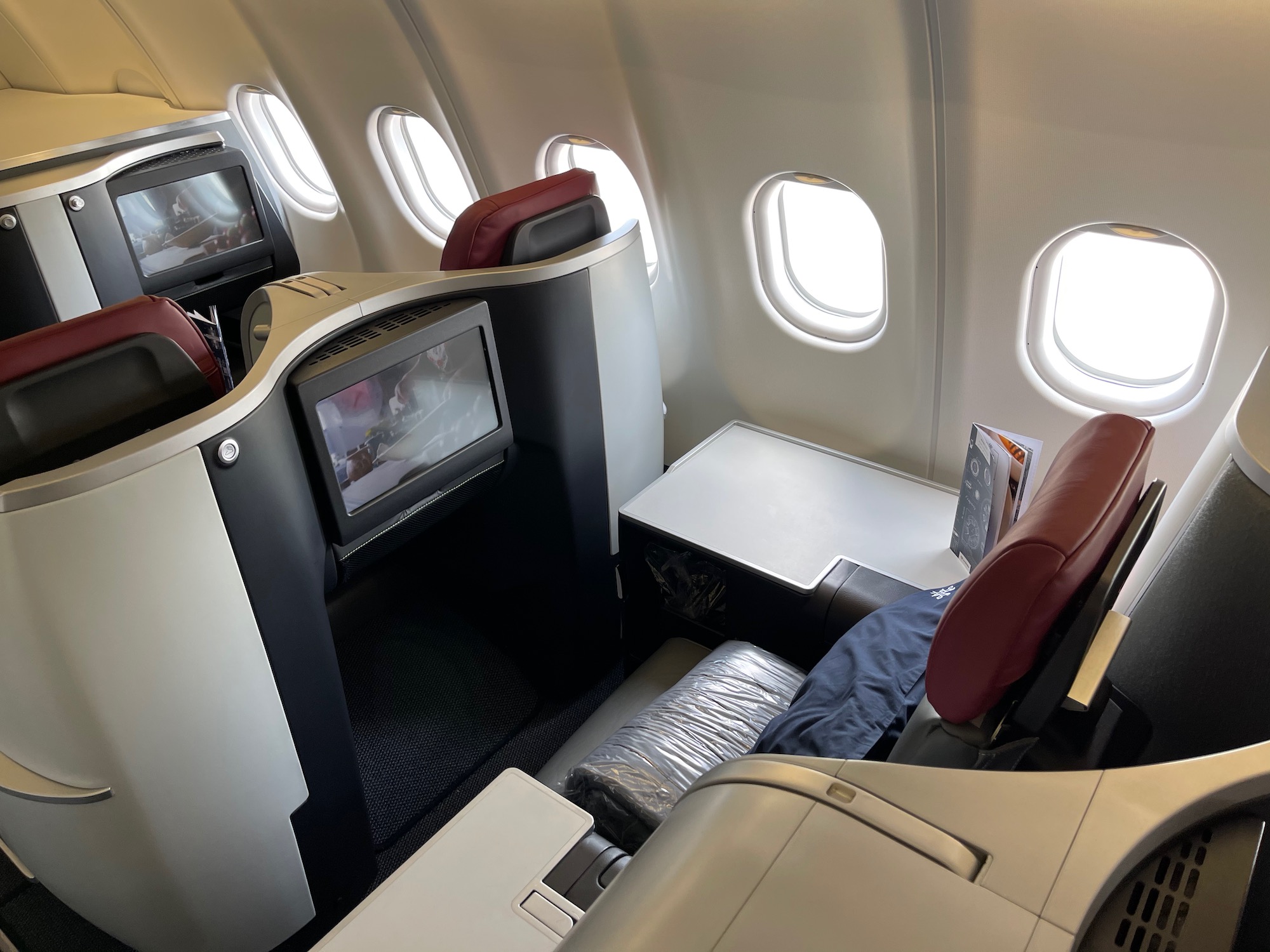 the inside of an airplane with windows and seats