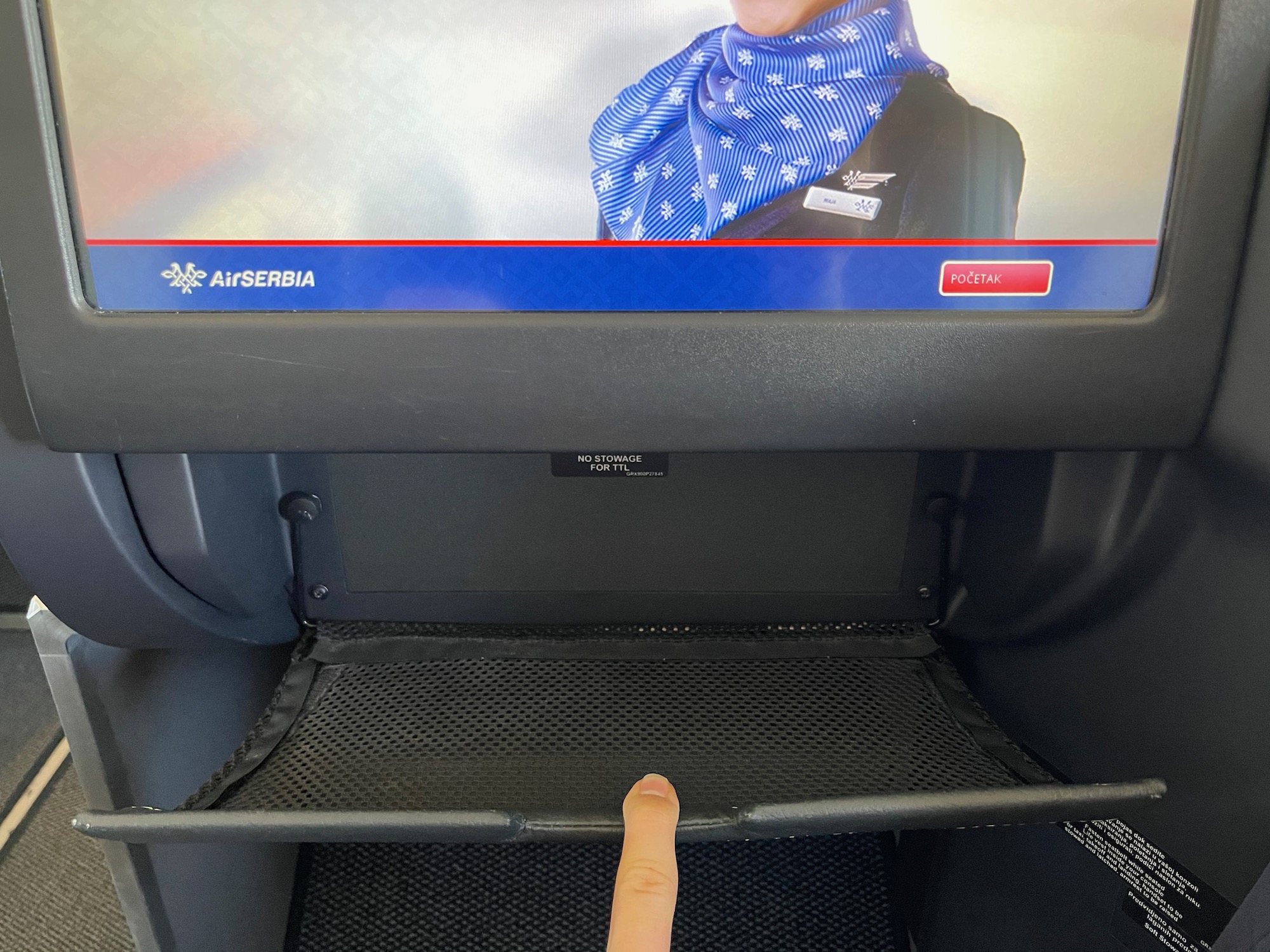 a finger pointing at a screen