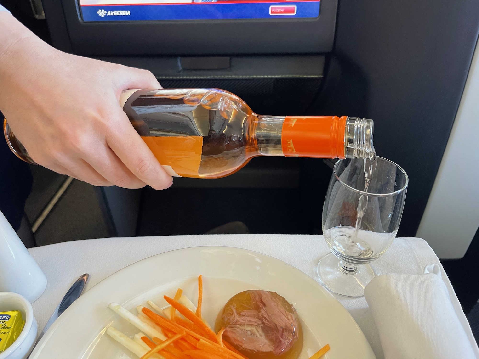 a person pouring a drink into a glass