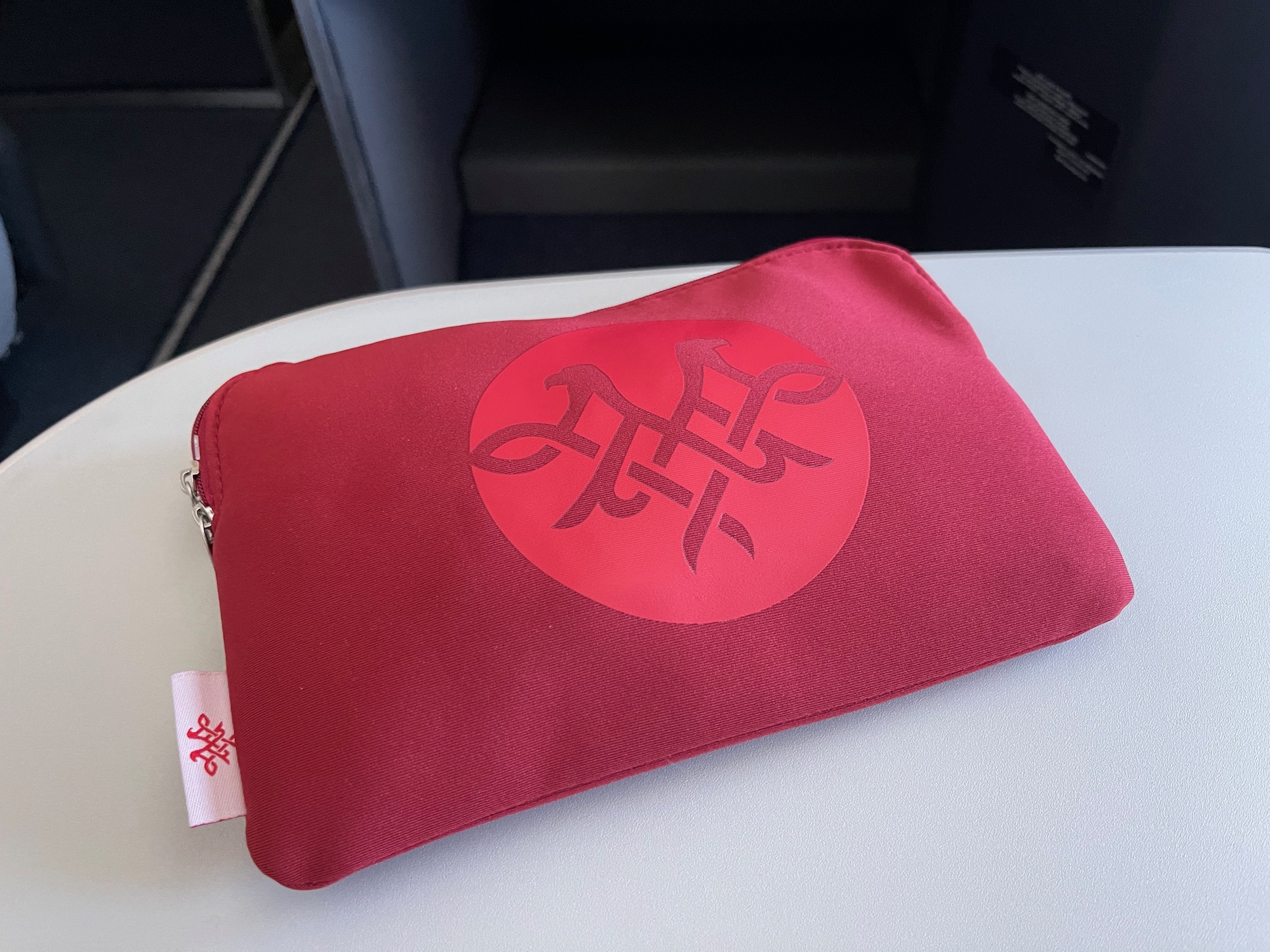 a red pouch with a logo on it