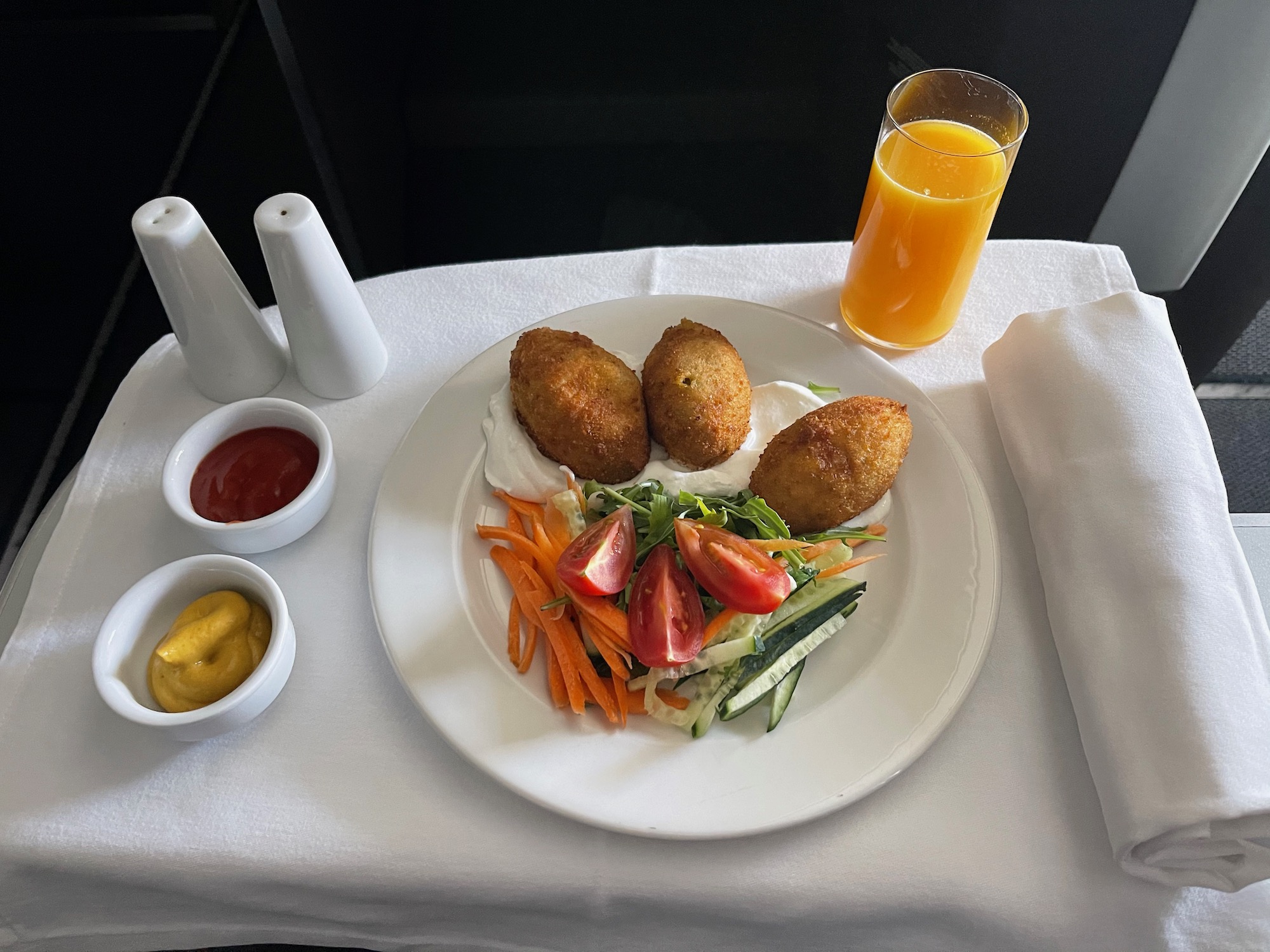 a plate of food and a glass of juice