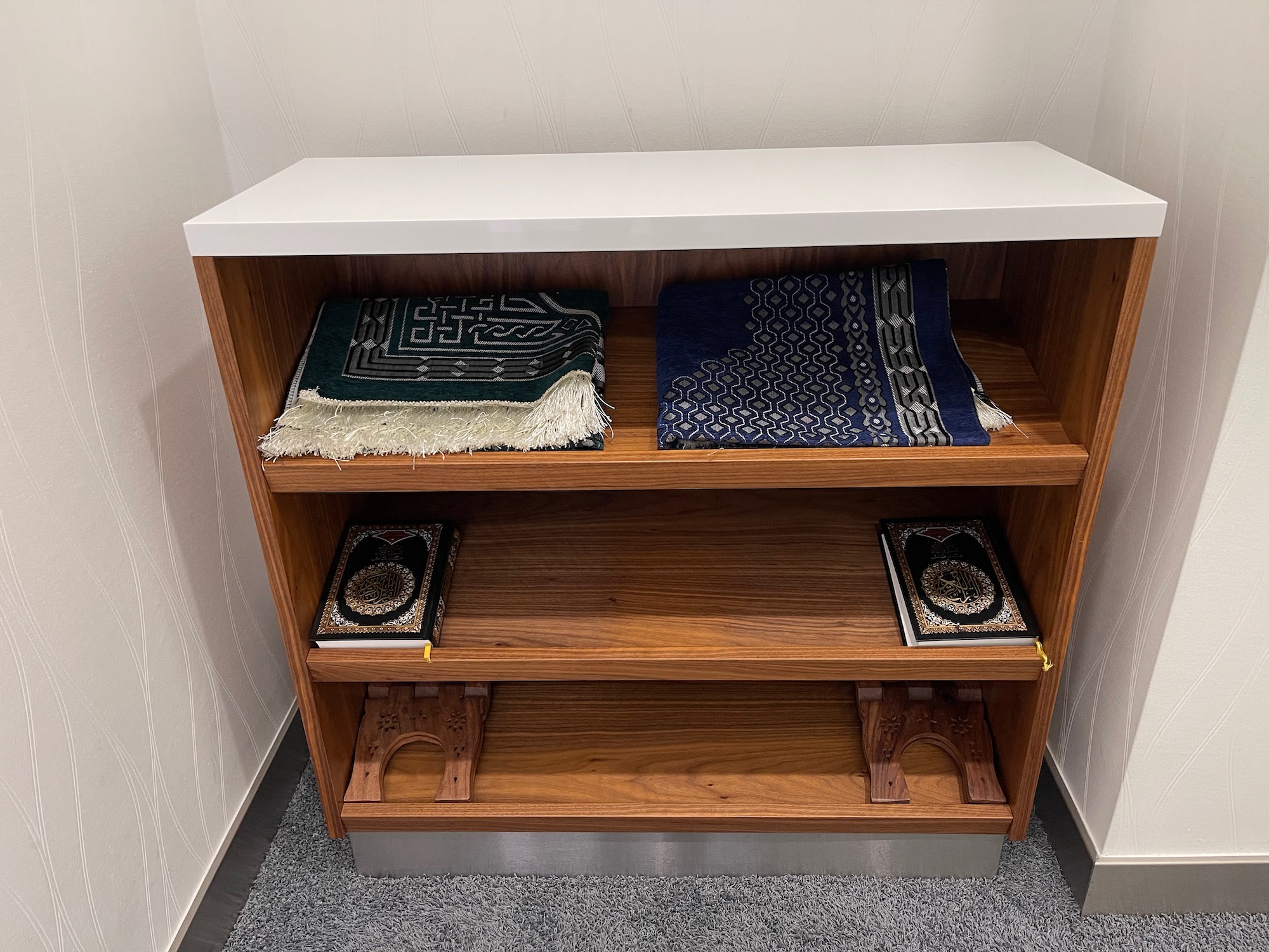 a shelf with blankets on it