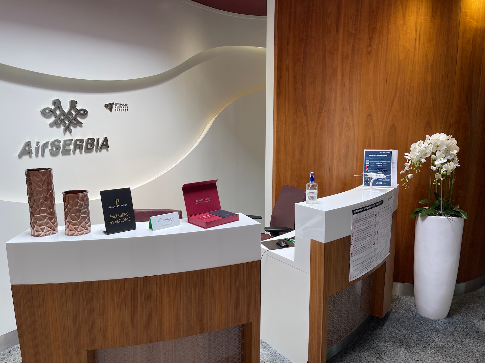 a reception desk with a sign on the wall