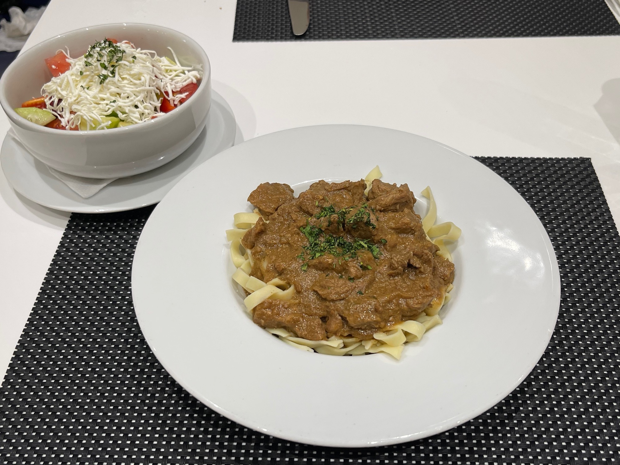 a plate of food and a bowl of noodles