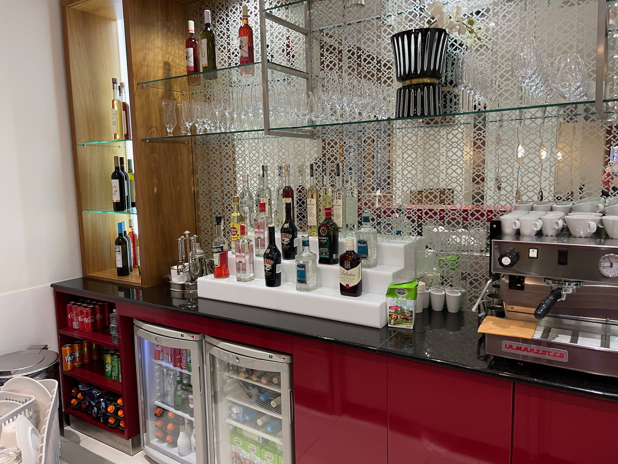 a bar with bottles of alcohol and a refrigerator