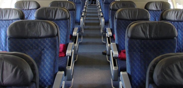 a row of blue seats on an airplane