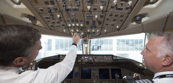 two men in the cockpit of an airplane