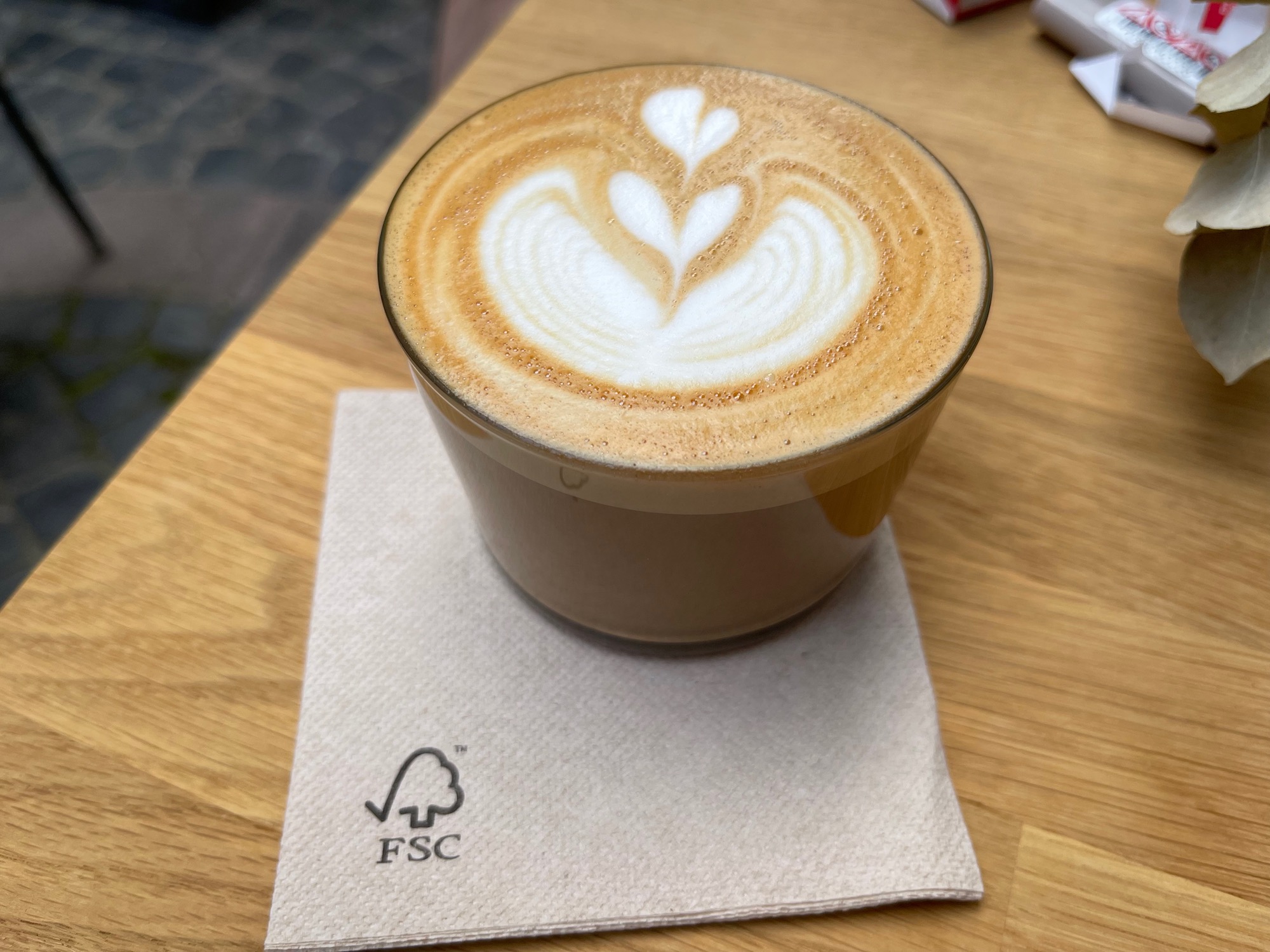 a cup of coffee with a heart design in the foam