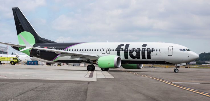 a large white and black airplane on a runway