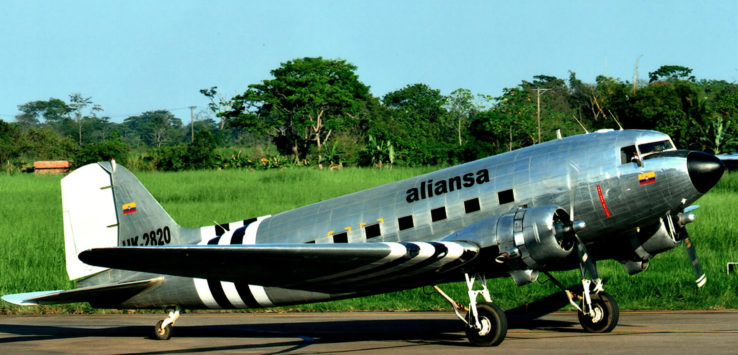 a silver airplane on a runway