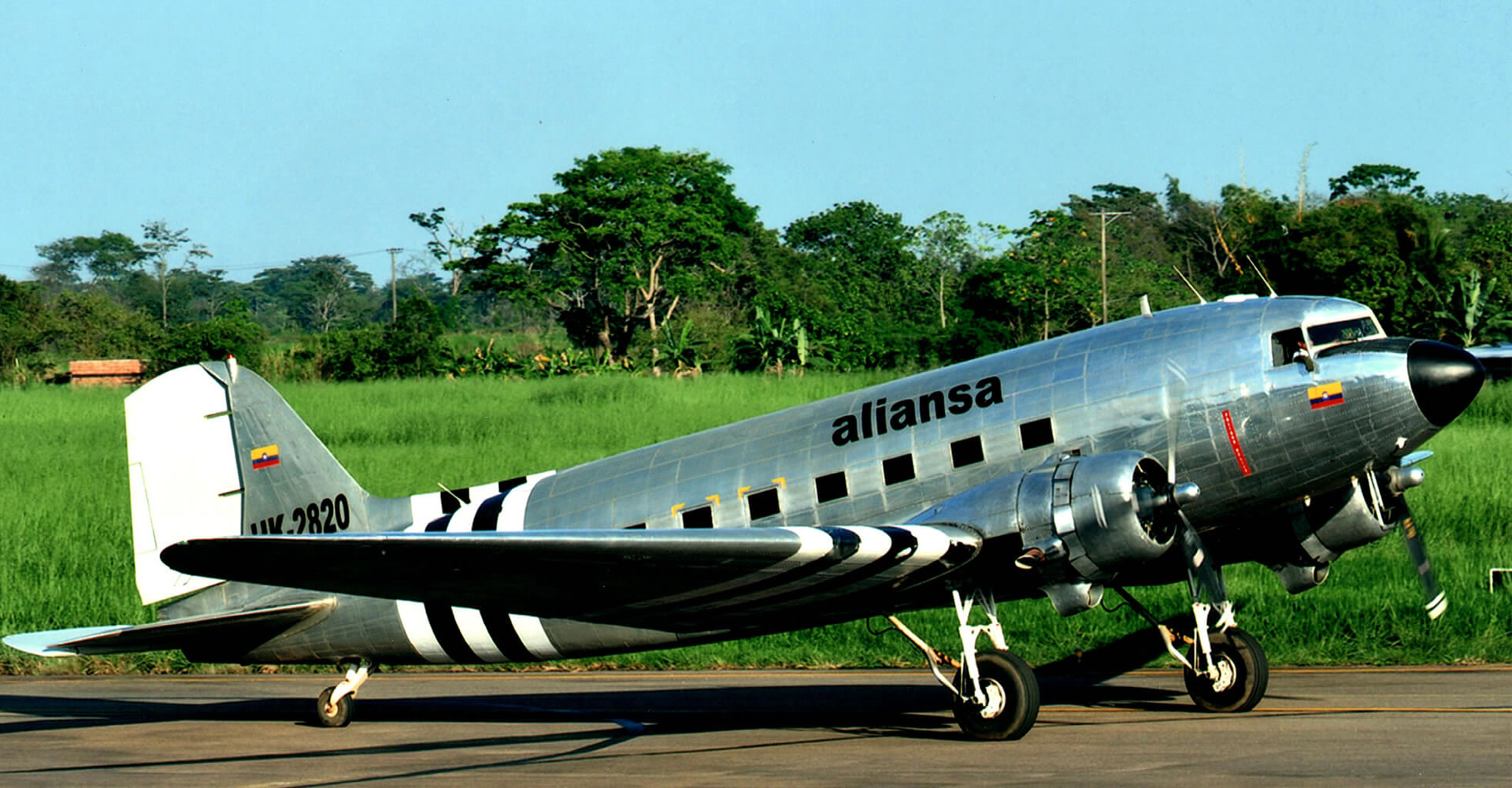 a silver airplane on a runway