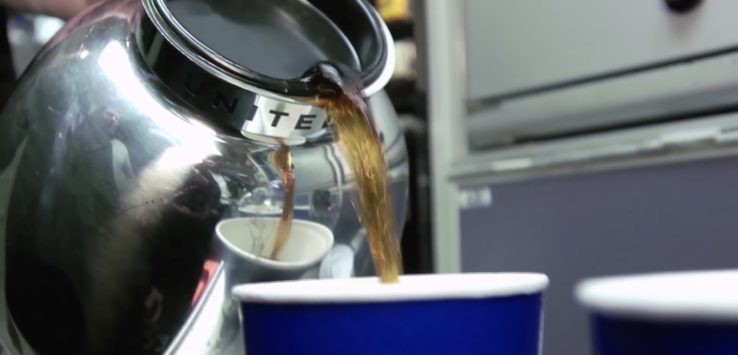 a coffee being poured into a cup