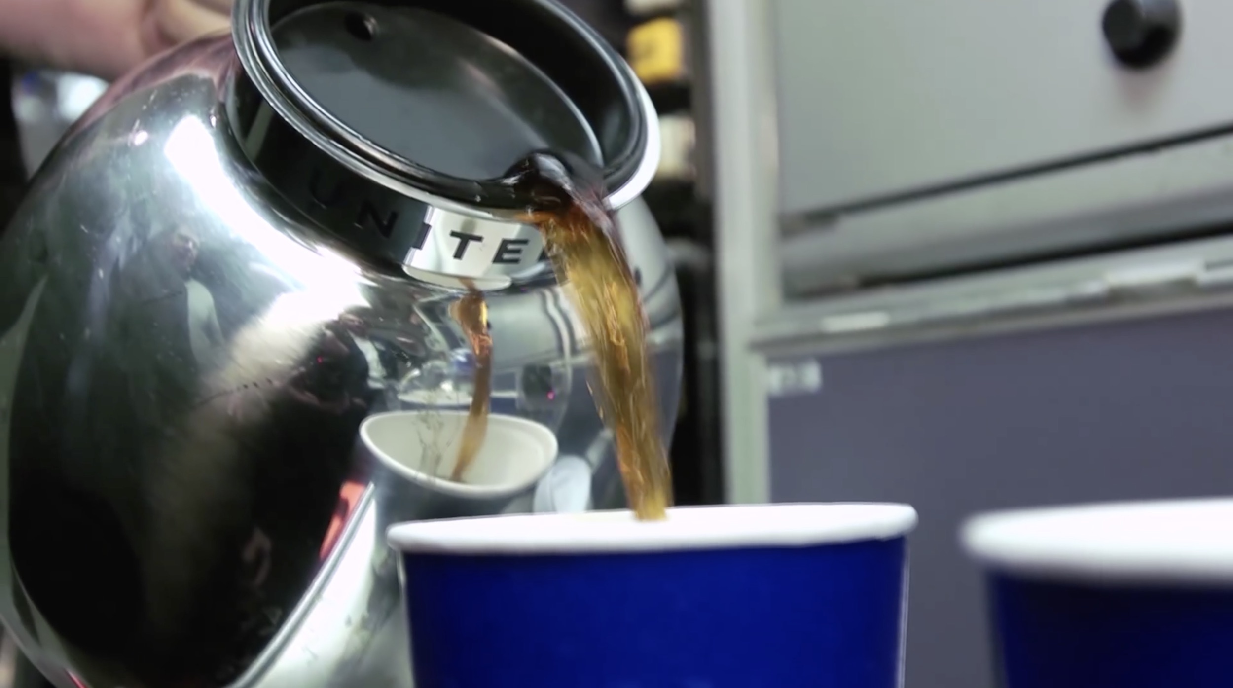 a coffee being poured into a cup