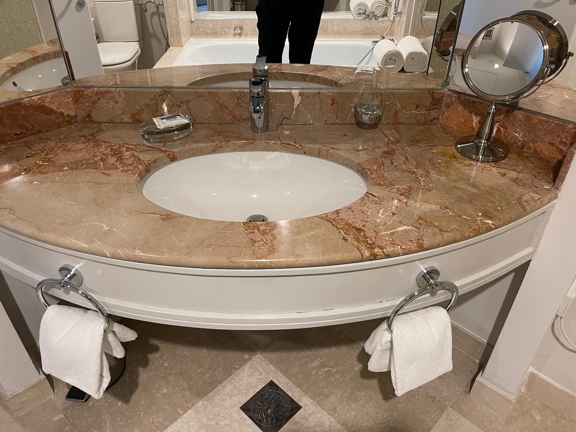 a bathroom sink with a marble counter top