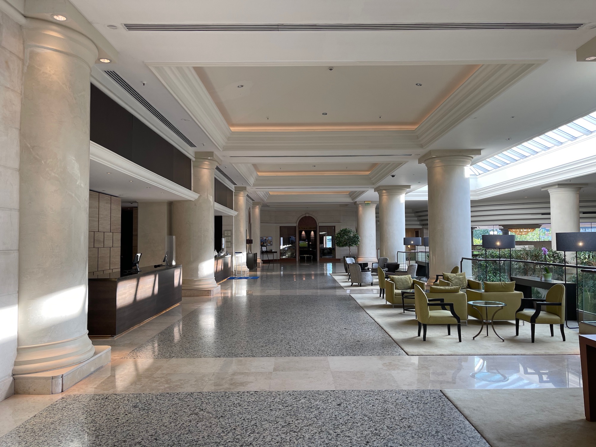 a lobby with a marble floor and columns