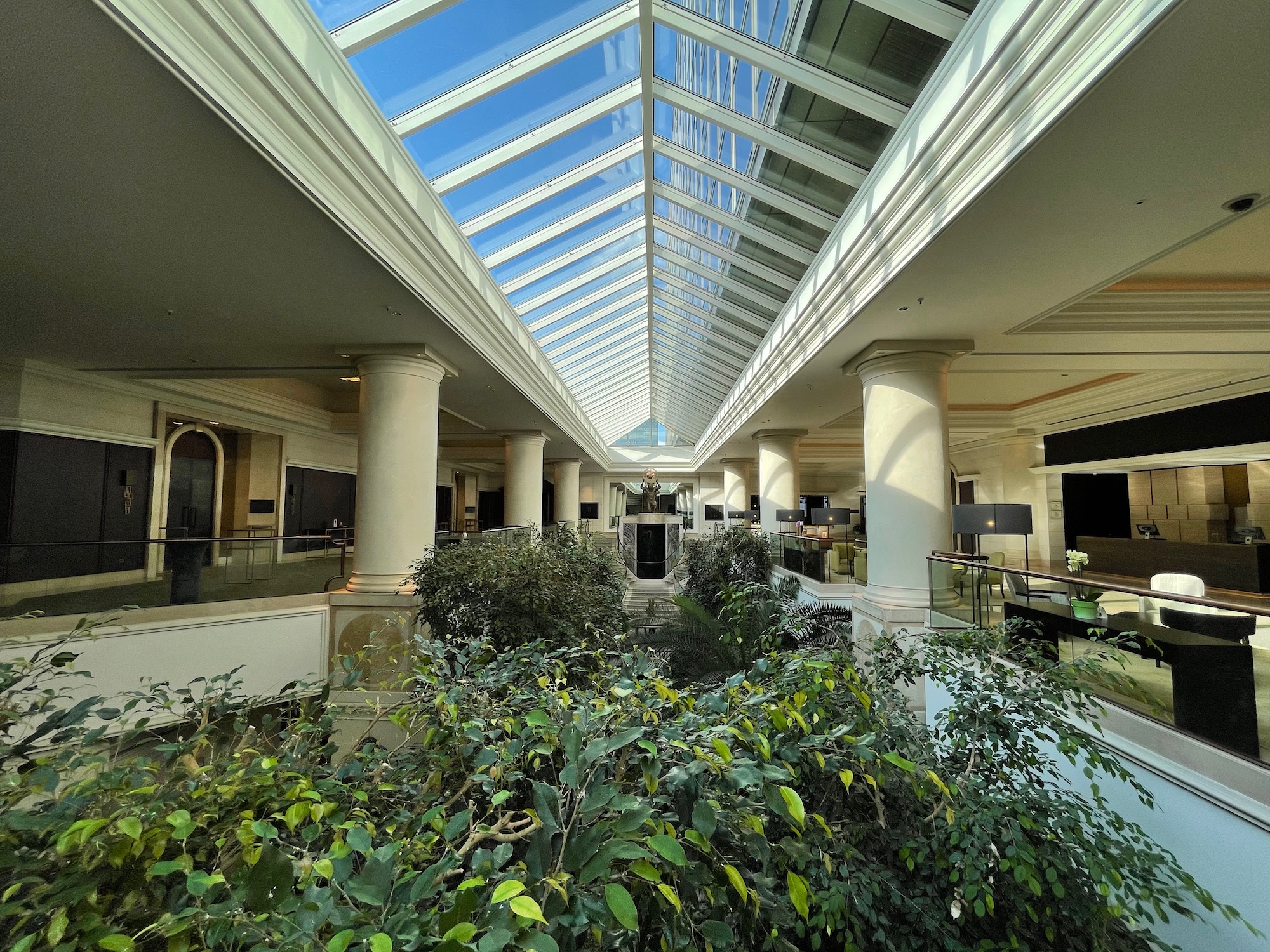a building with a glass roof and plants